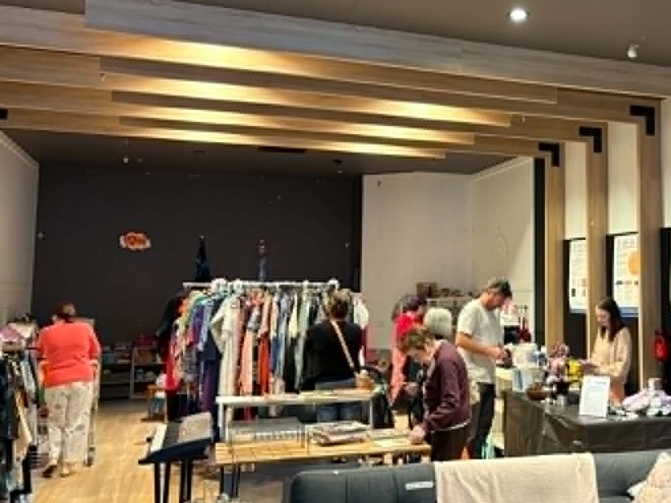 Inside the House of Alms Pop-Up Op Shop at the Hyperdome — shoppers browsing clothing racks and homewares